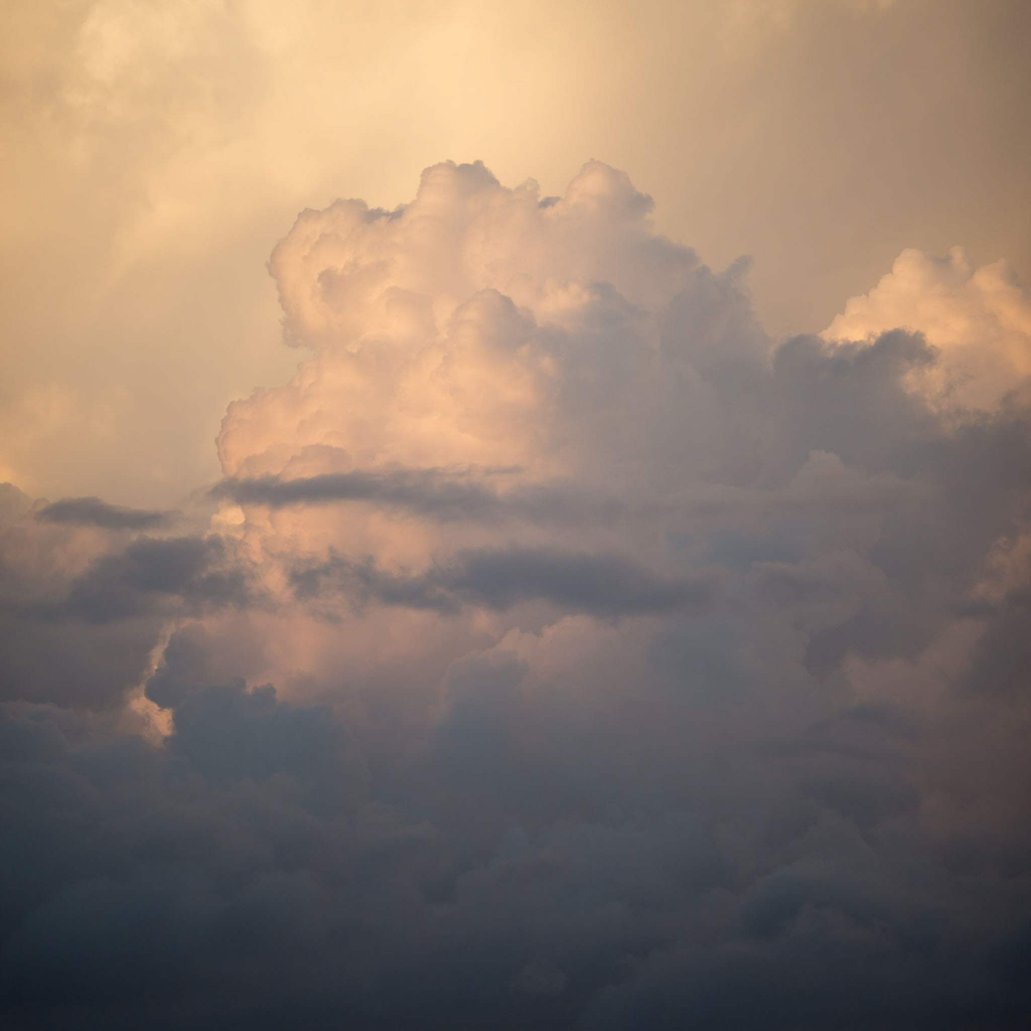 Warm amber clouds billowing with golden light