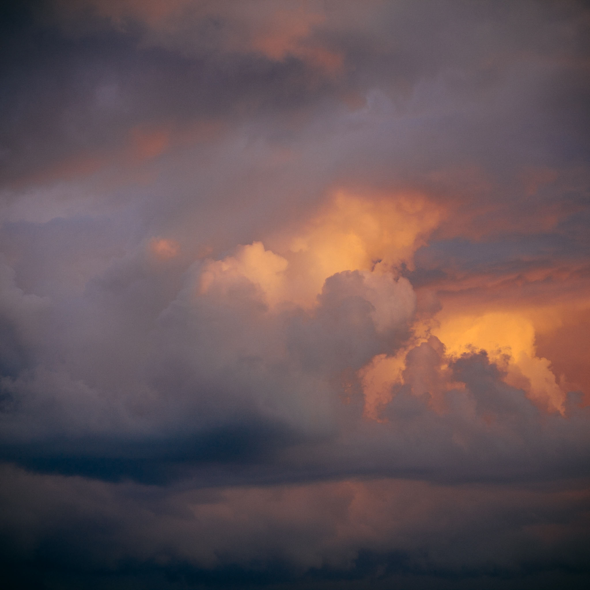 Layers of amber and purple sunset clouds