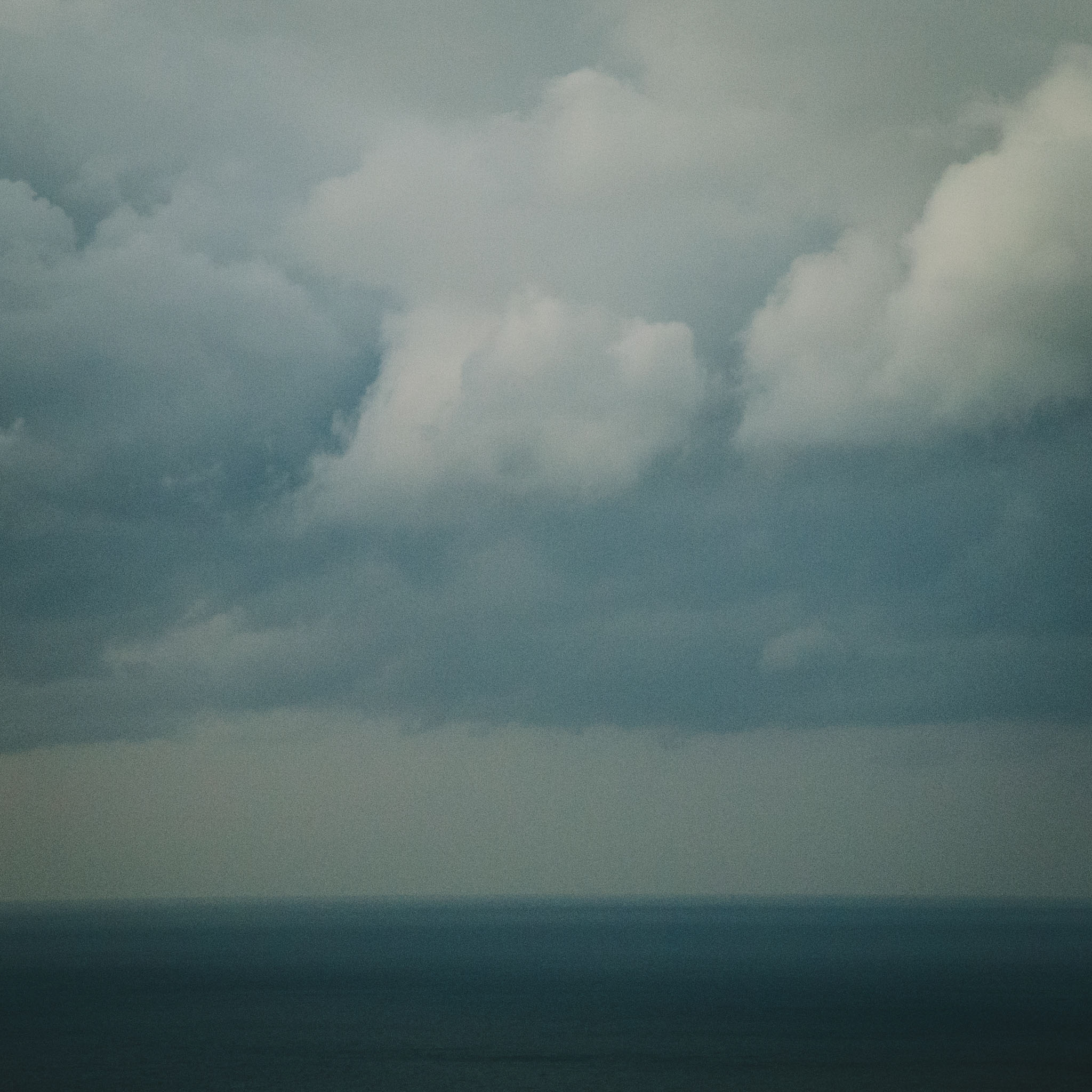 Clouds and water merging at the horizon