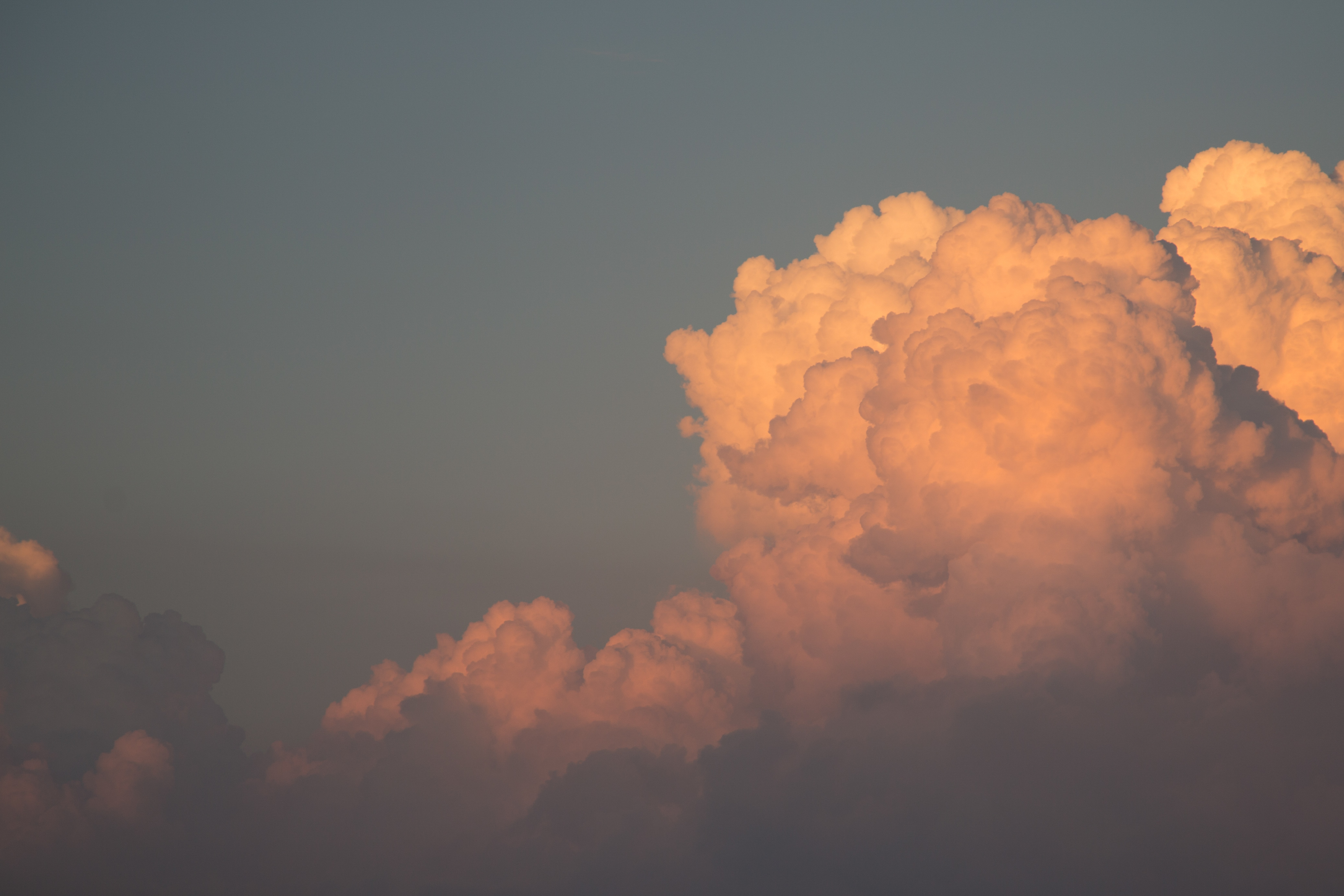 Towering golden cumulus clouds lit by sunset